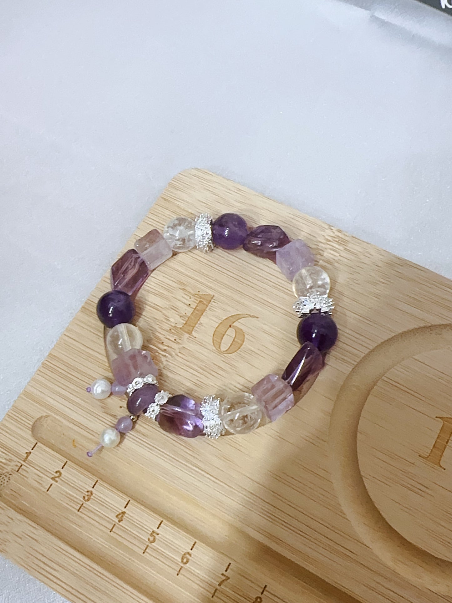 Beaded bracelet on a wooden surface with measurement markings