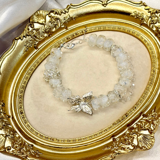 Handmade white glass bead butterfly bracelet on wrist — cottagecore fairy jewellery gift for her