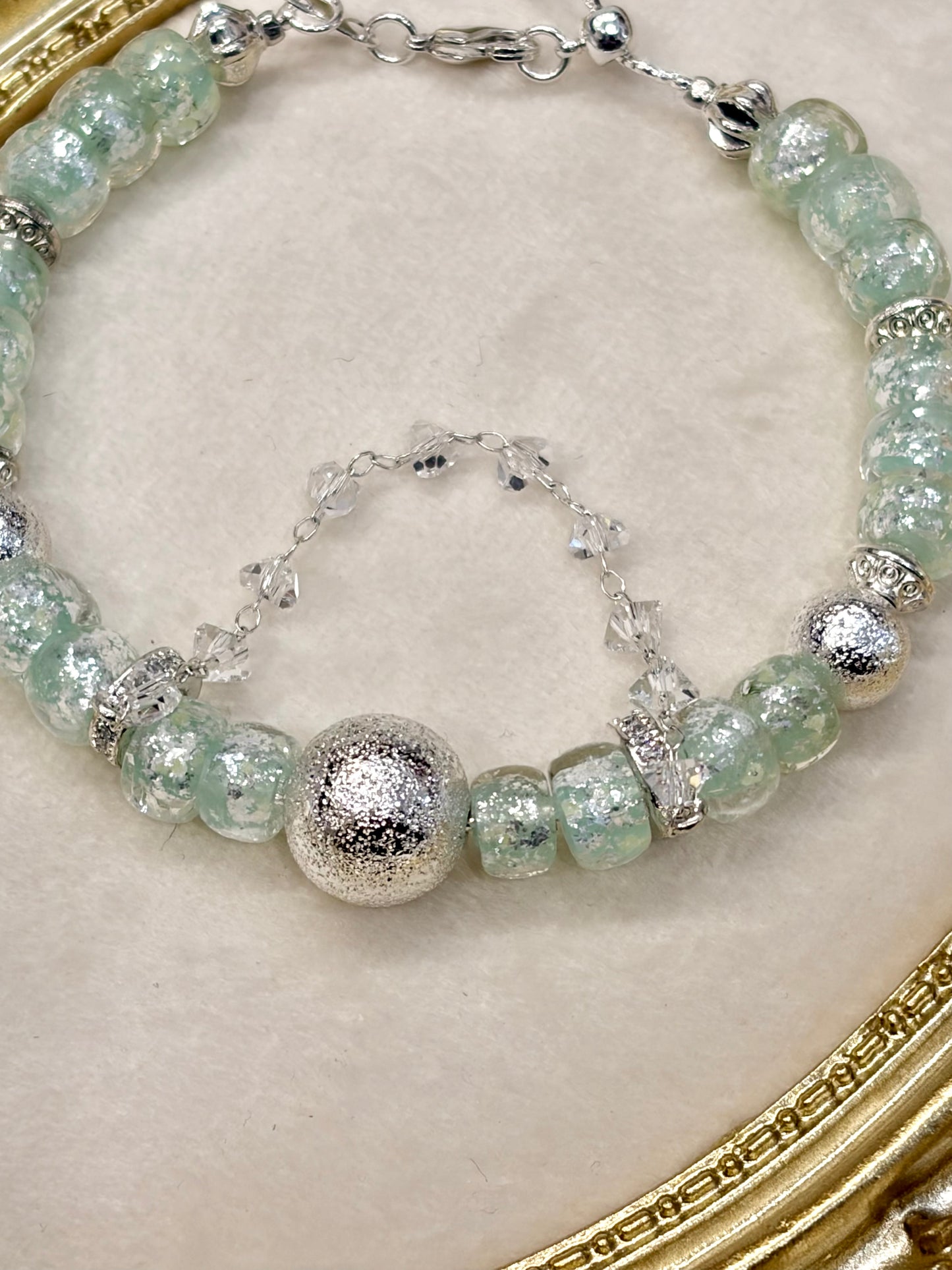 Close-up of mint green crackle glass beads with silver CZ spacer rings bracelet