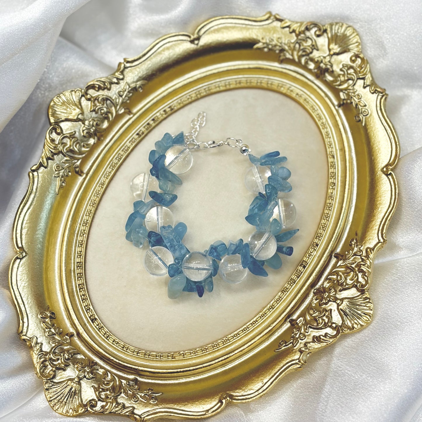 Handmade aquamarine chip and clear quartz bracelet displayed in gold ornate frame — natural blue crystal healing jewellery by XYD PLUS