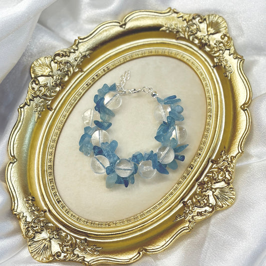Handmade aquamarine chip and clear quartz bracelet displayed in gold ornate frame — natural blue crystal healing jewellery by XYD PLUS