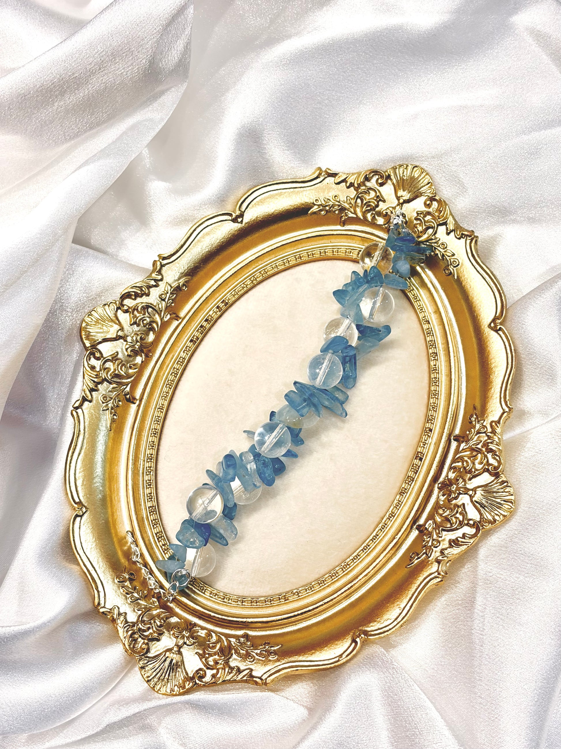 Aquamarine and clear quartz bracelet laid flat showing adjustable length and natural chip texture — ocean blue healing stone jewellery