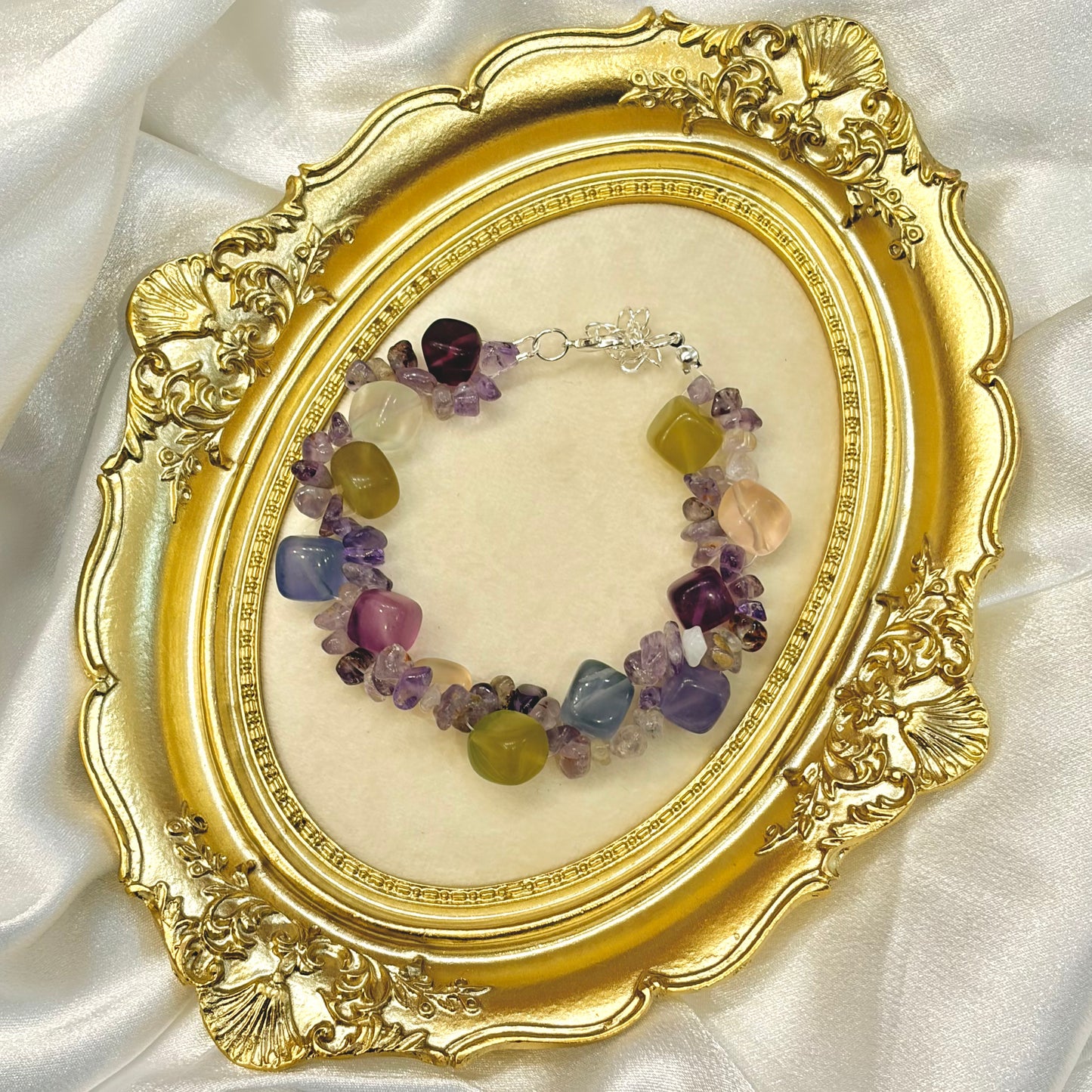 Handmade multicolor fluorite and amethyst bracelet displayed in gold ornate frame — purple green pink blue tumbled crystal jewellery by XYD PLUS
