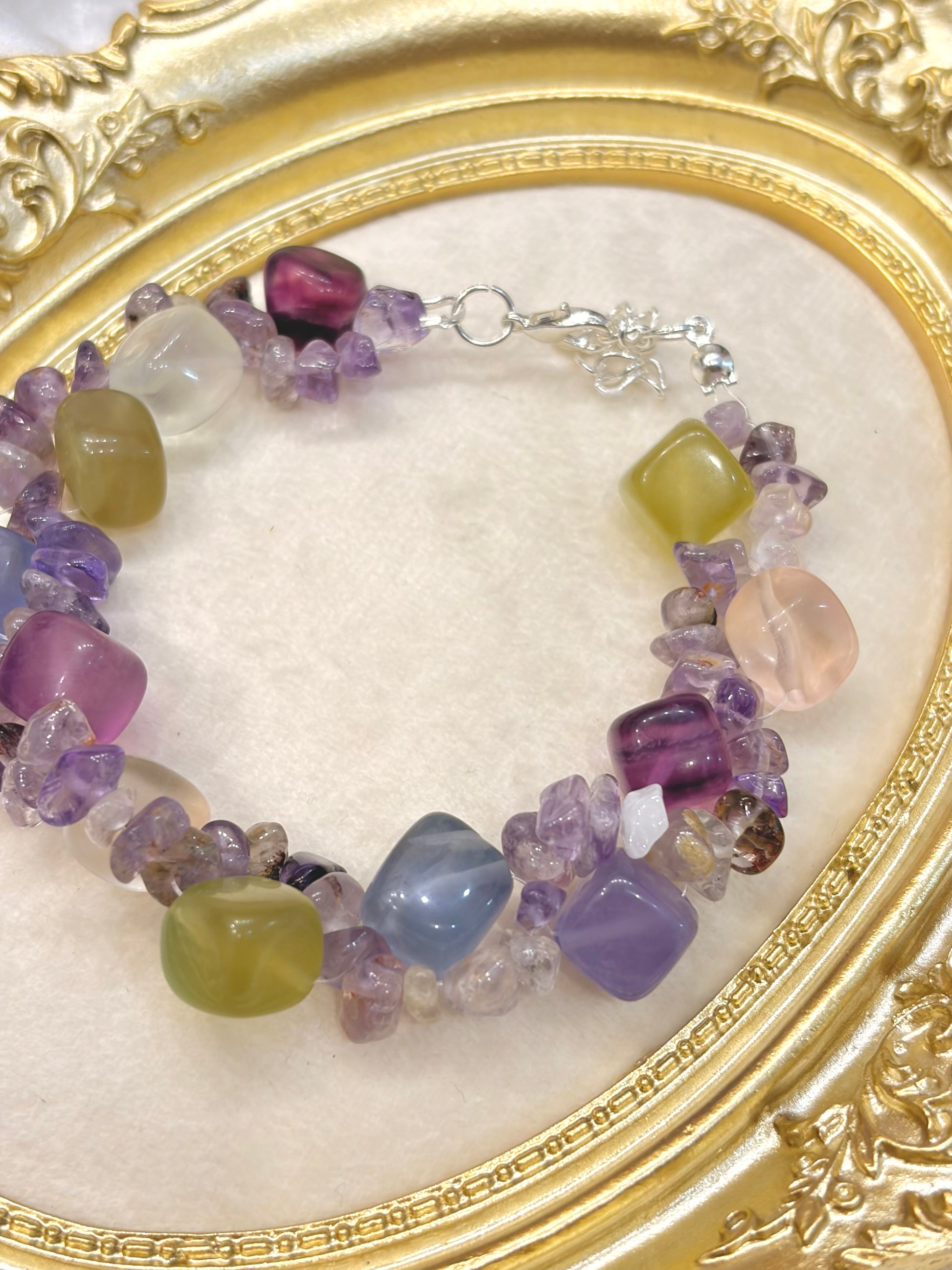 Close-up of tumbled fluorite nuggets in purple, green, pink and blue with raw amethyst chip spacers — adjustable handmade crystal bracelet