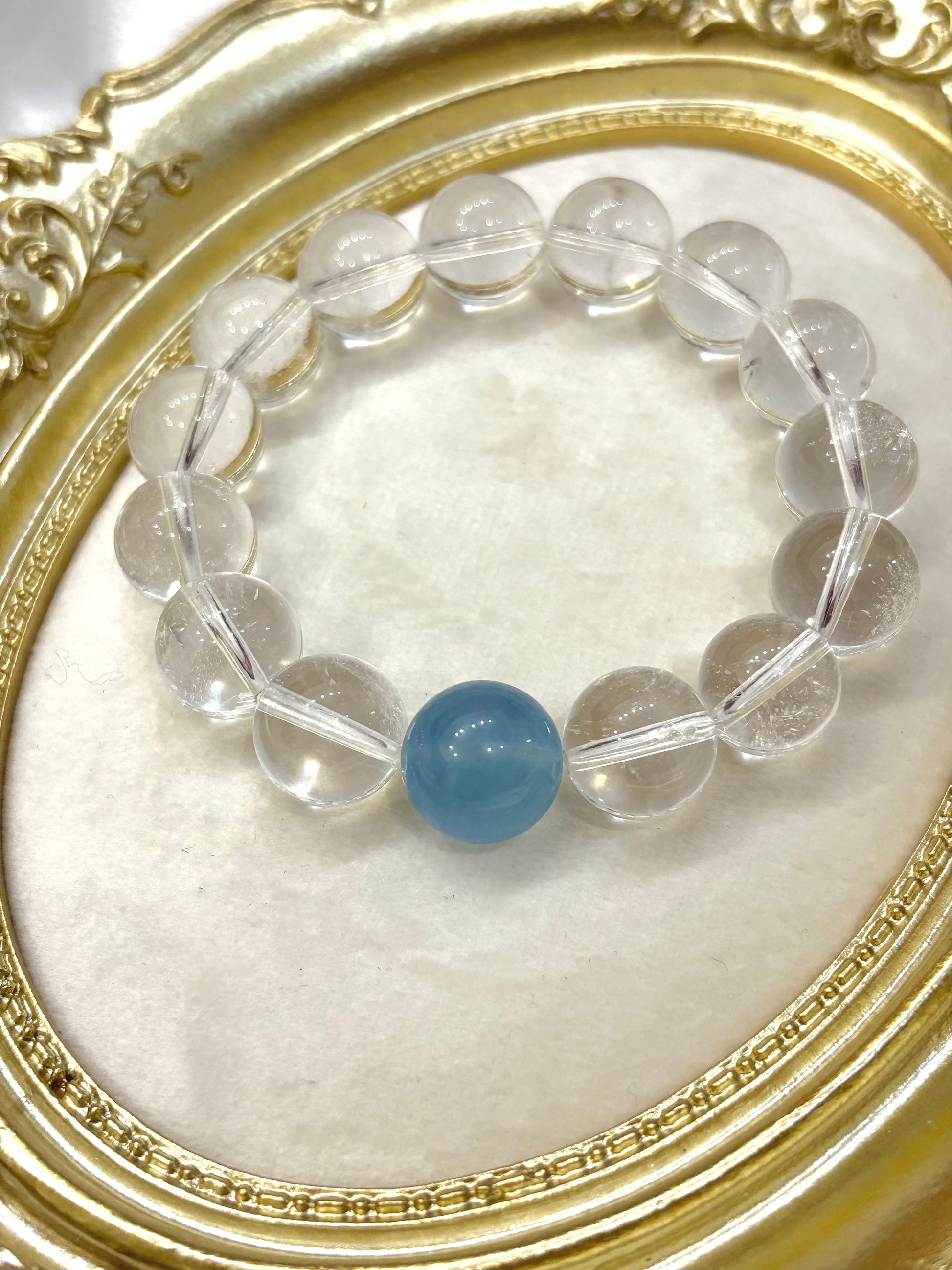 Close-up of 13mm clear quartz beads with sky blue aquamarine center stone — minimalist natural gemstone bracelet handmade in Australia