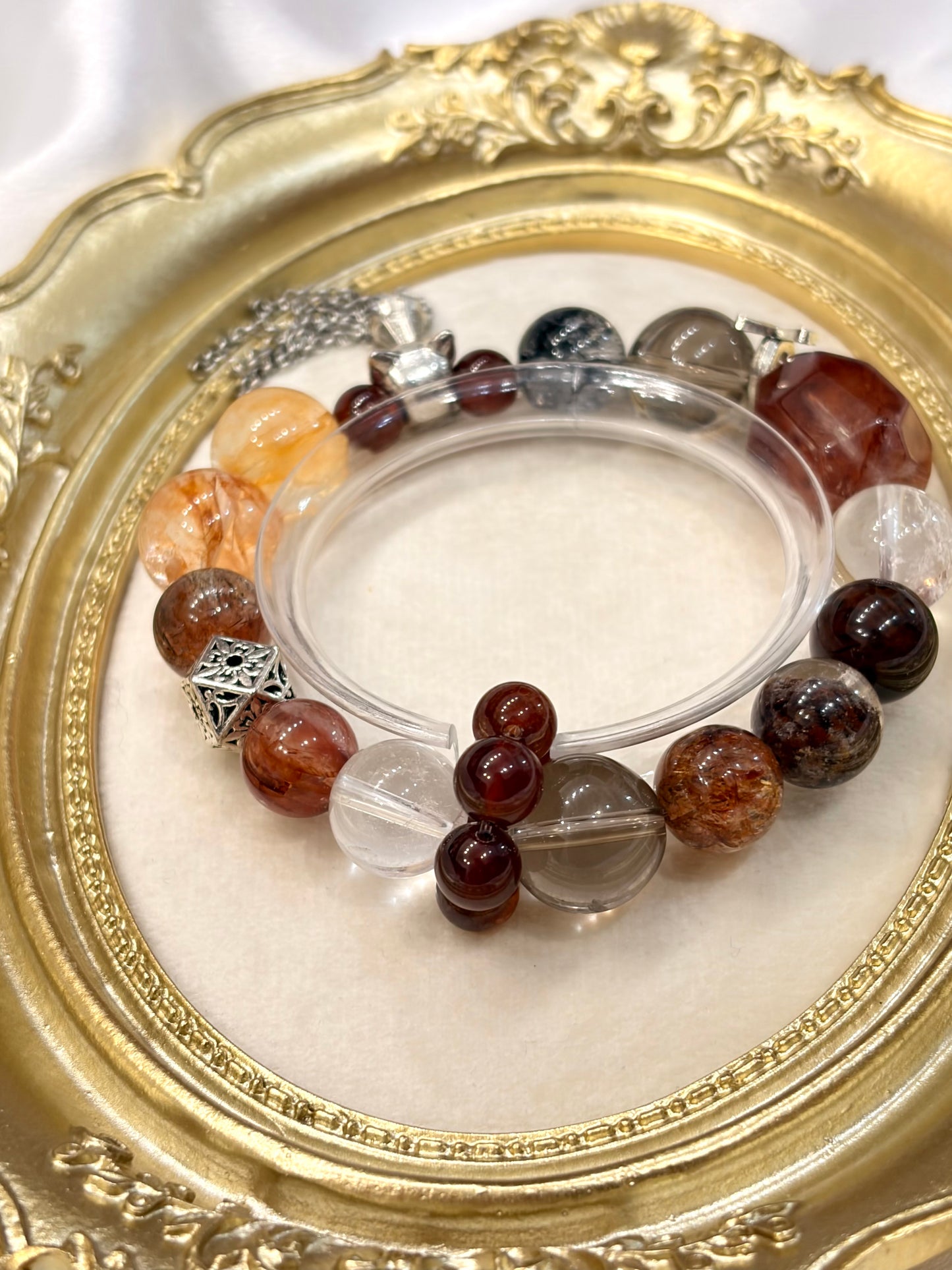 Close-up of obsidian clear quartz smoky quartz and garnet beads on crystal bracelet