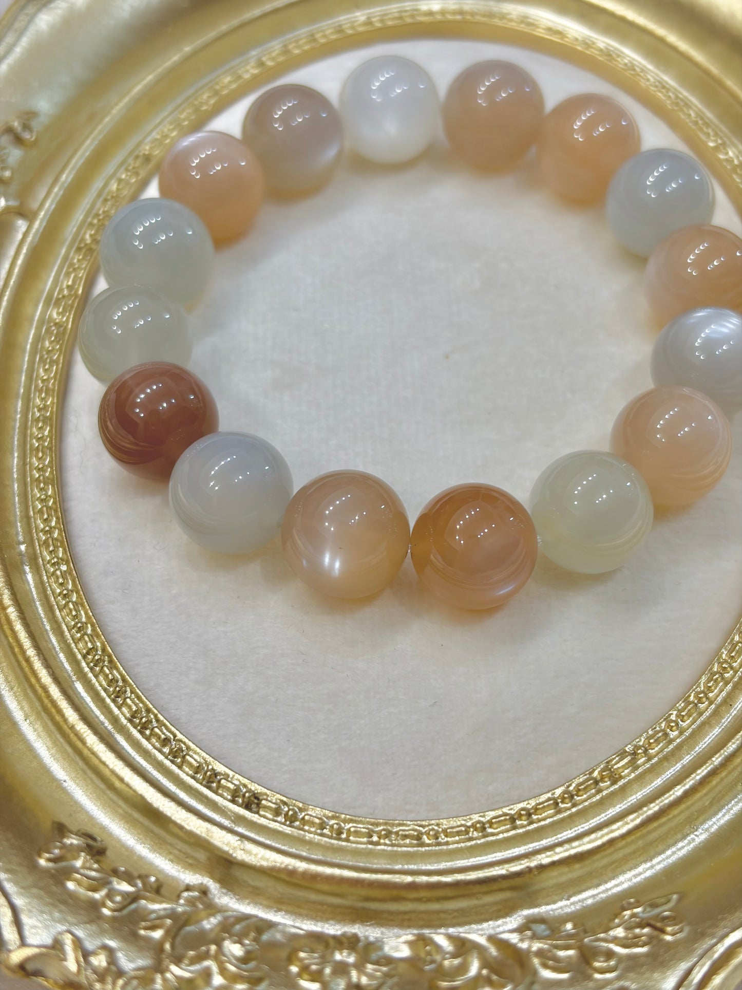 Beaded bracelet with multicolored beads on a decorative gold frame