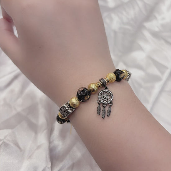 Black and gold beaded bracelet on wrist — handmade adjustable bracelet women