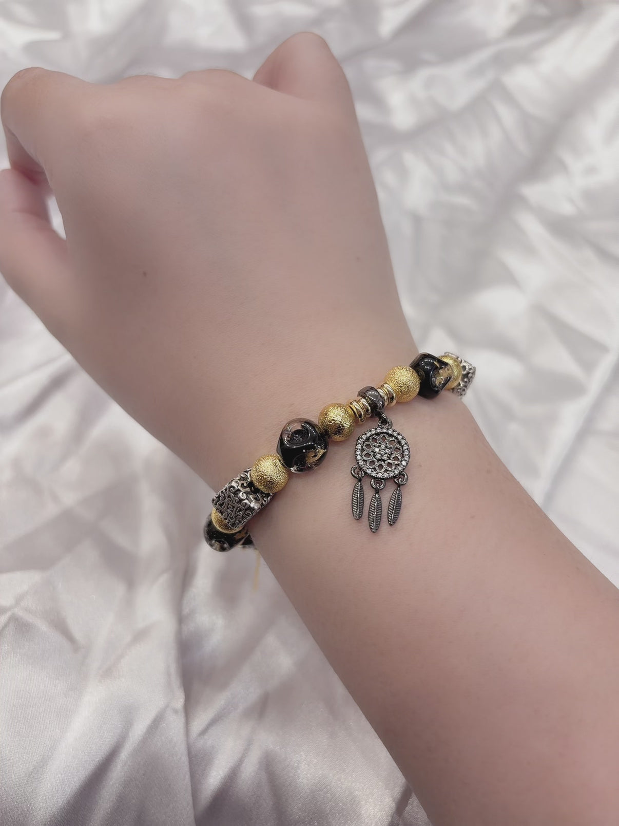 Black and gold beaded bracelet on wrist — handmade adjustable bracelet women
