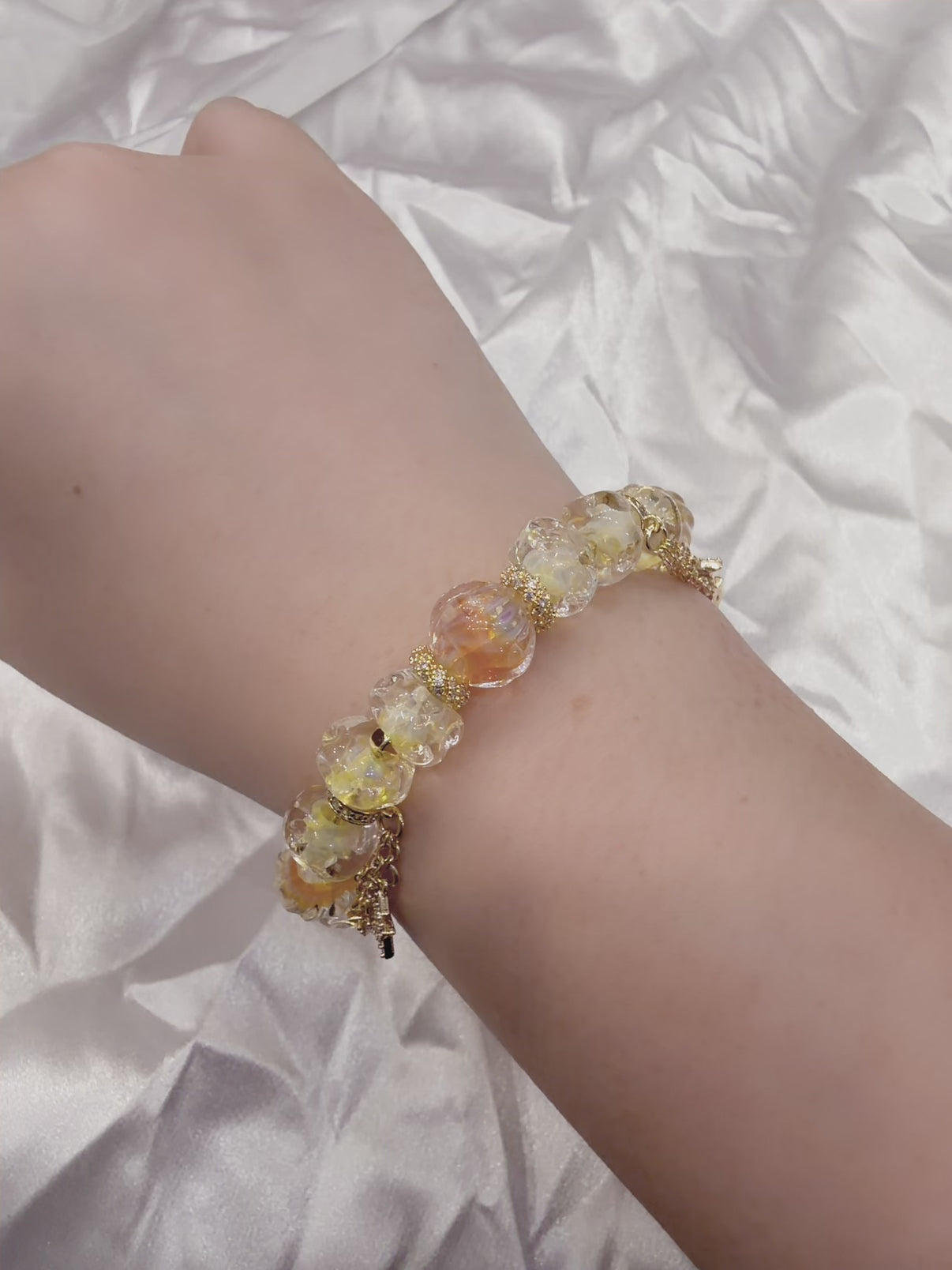 Adjustable amber glass bead bracelet catching light — Y2K celestial jewellery Australia New Zealand